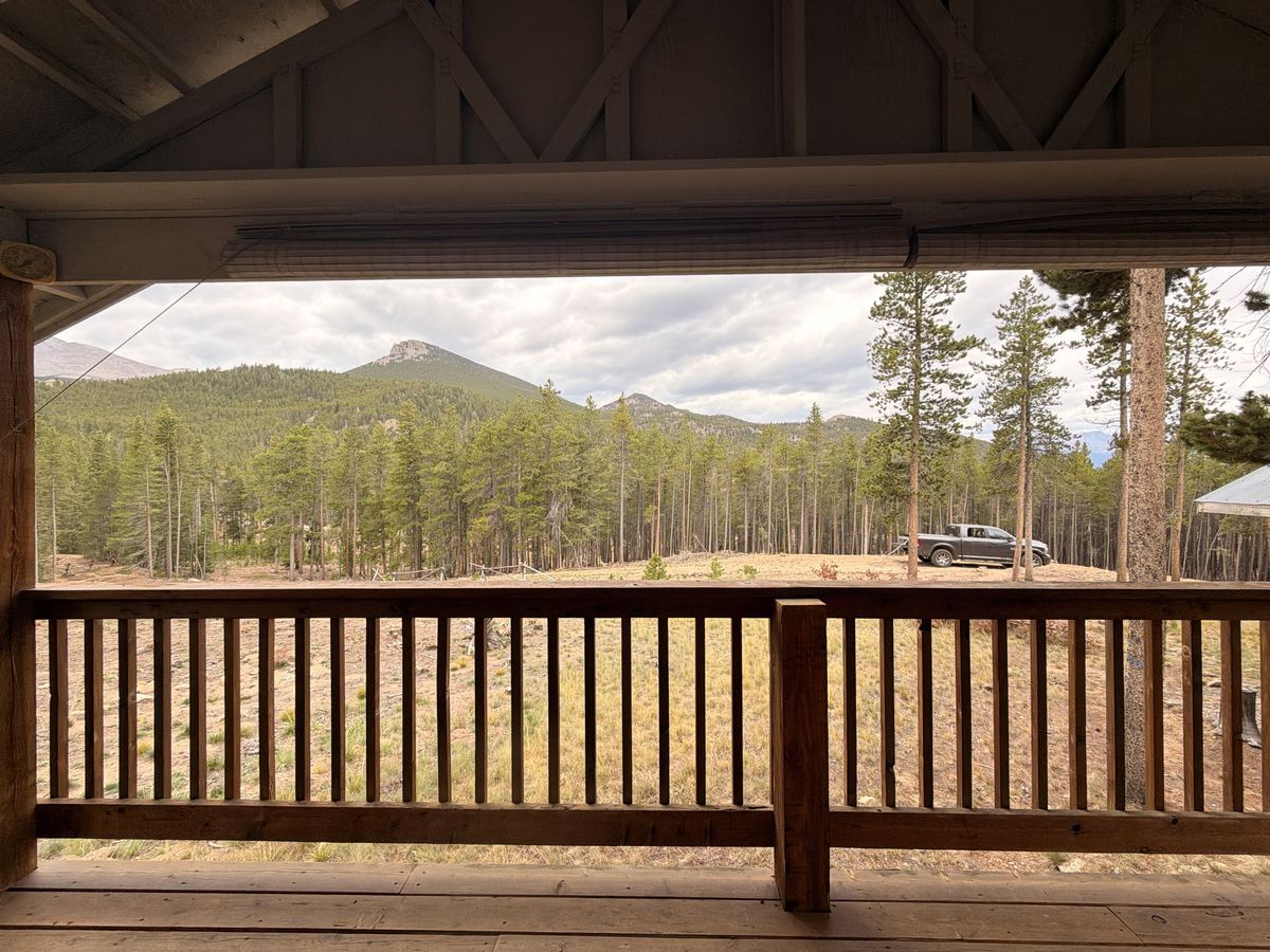 View of the mountains from the cabin porch with the truck parked nearby
