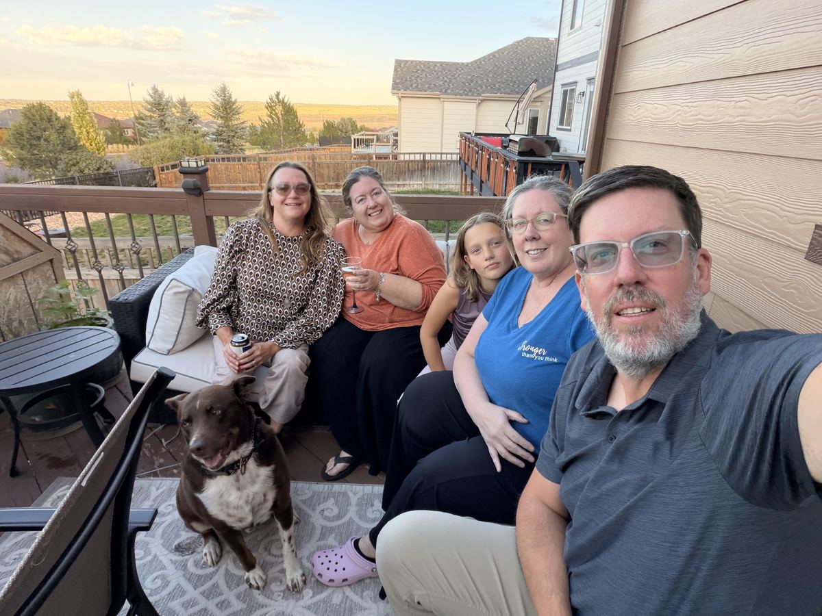 The whole crew plus Bear on the deck couch